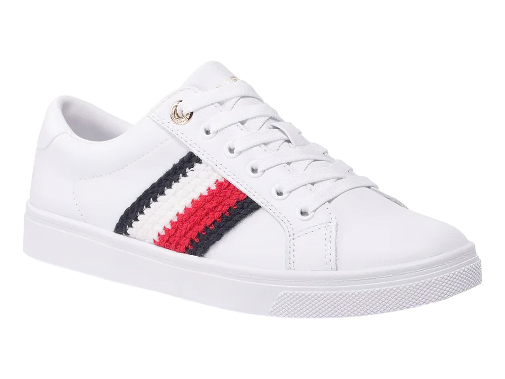 Tenis blancos Tommy Hilfiger con franjas laterales en rojo, blanco y azul marino y suela blanca.
