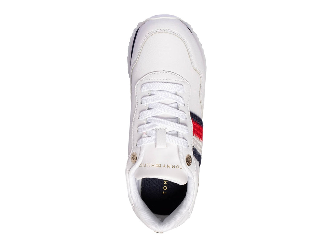 Tenis Tommy Hilfiger blancos con franja lateral en azul, blanco y rojo y suela blanca.