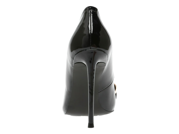 Zapato de tacón alto negro brillante con punta fina y adorno de cadena dorada en la parte frontal.