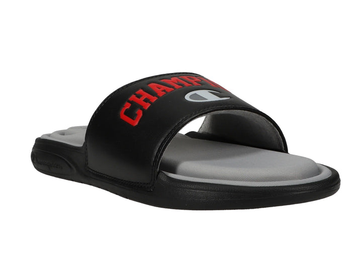 Sandalia tipo slide Champion en color negro con plantilla gris y logotipo en rojo.