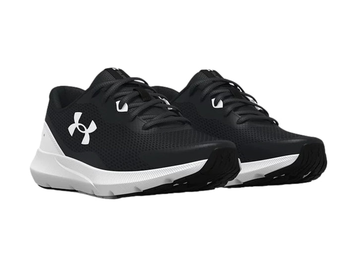 Tenis deportivos Under Armour para niño en color negro con suela blanca y logotipo blanco lateral.