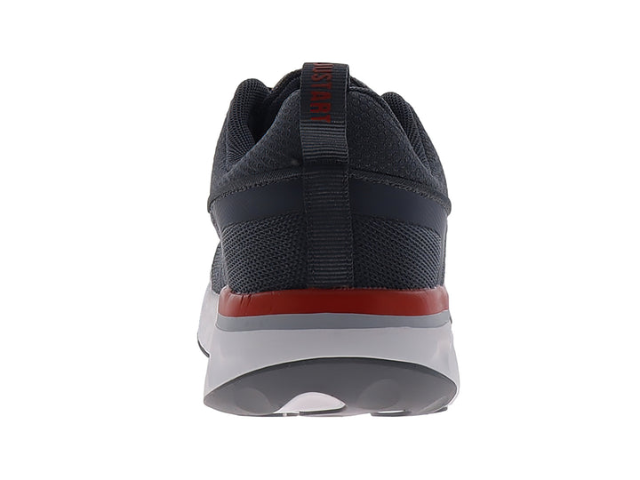Tenis de baloncesto JUSTART color gris oscuro con suela blanca y un detalle en rojo.