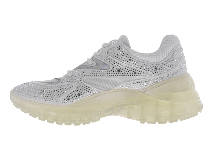 Tenis blancos de la marca GUESS con detalles brillantes en el exterior y suela gruesa translúcida.