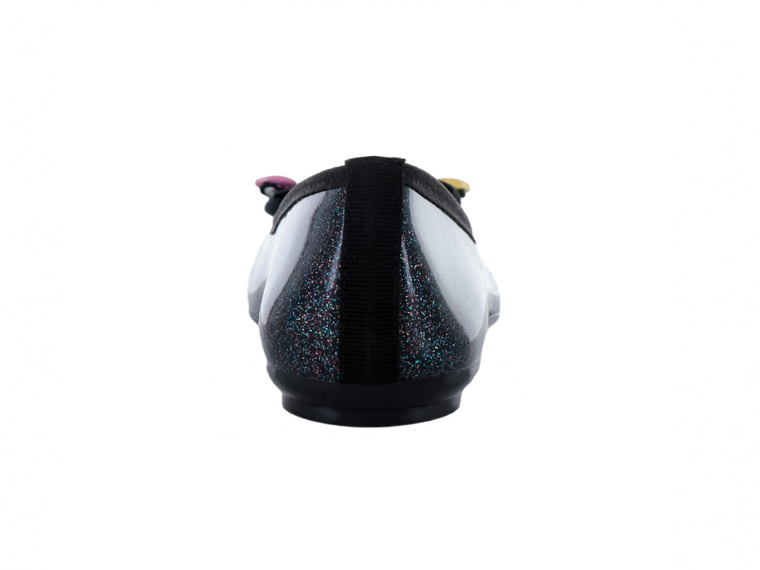 Zapato plano negro con acabado brillante y glitter, decorado con un moño negro y pequeños corazones amarillos y rosas.