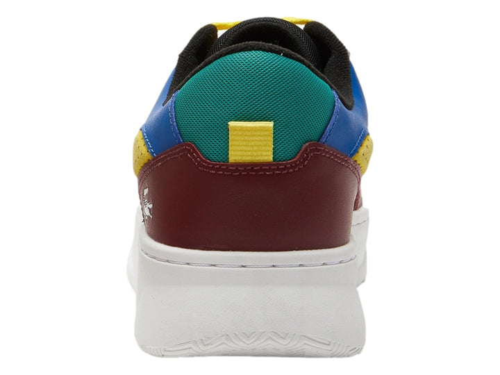 Tenis Lacoste L005 multicolor en blanco, burgundy, azul, verde y amarillo con suela blanca gruesa.