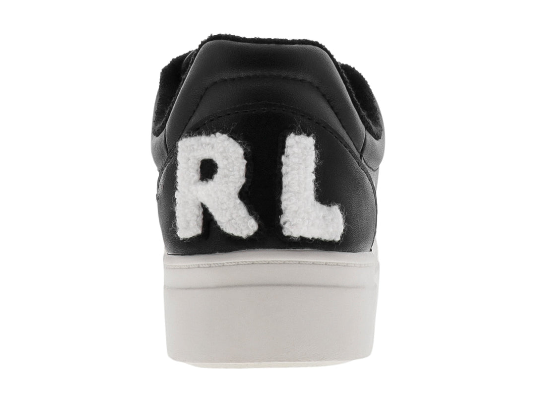 Tenis negros de plataforma con suela blanca y detalles perforados.