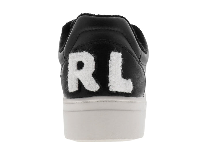 Tenis negros de plataforma con suela blanca y detalles perforados.