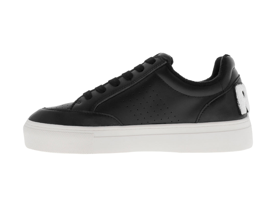 Tenis negros de plataforma con suela blanca y detalles perforados.