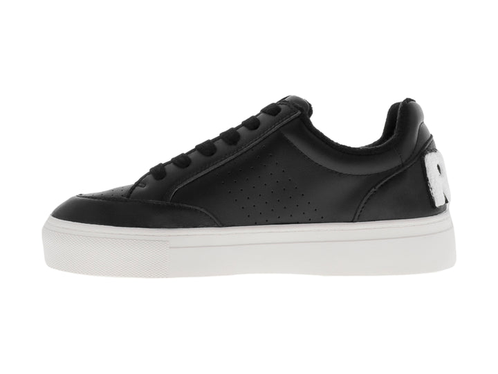 Tenis negros de plataforma con suela blanca y detalles perforados.