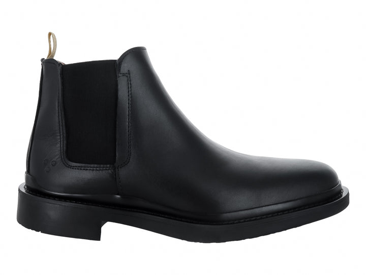Bota Chelsea de color negro con suela gruesa y tirador beige en el talón.
