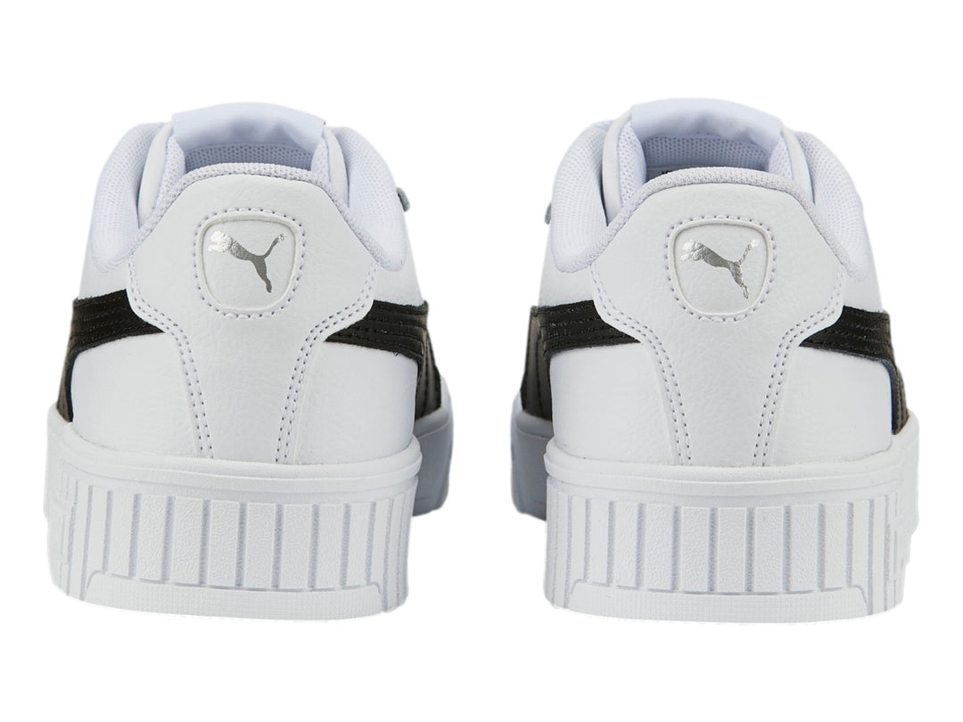 Tenis PUMA Carina 2.0 blancos con franja negra lateral y suela de plataforma blanca.