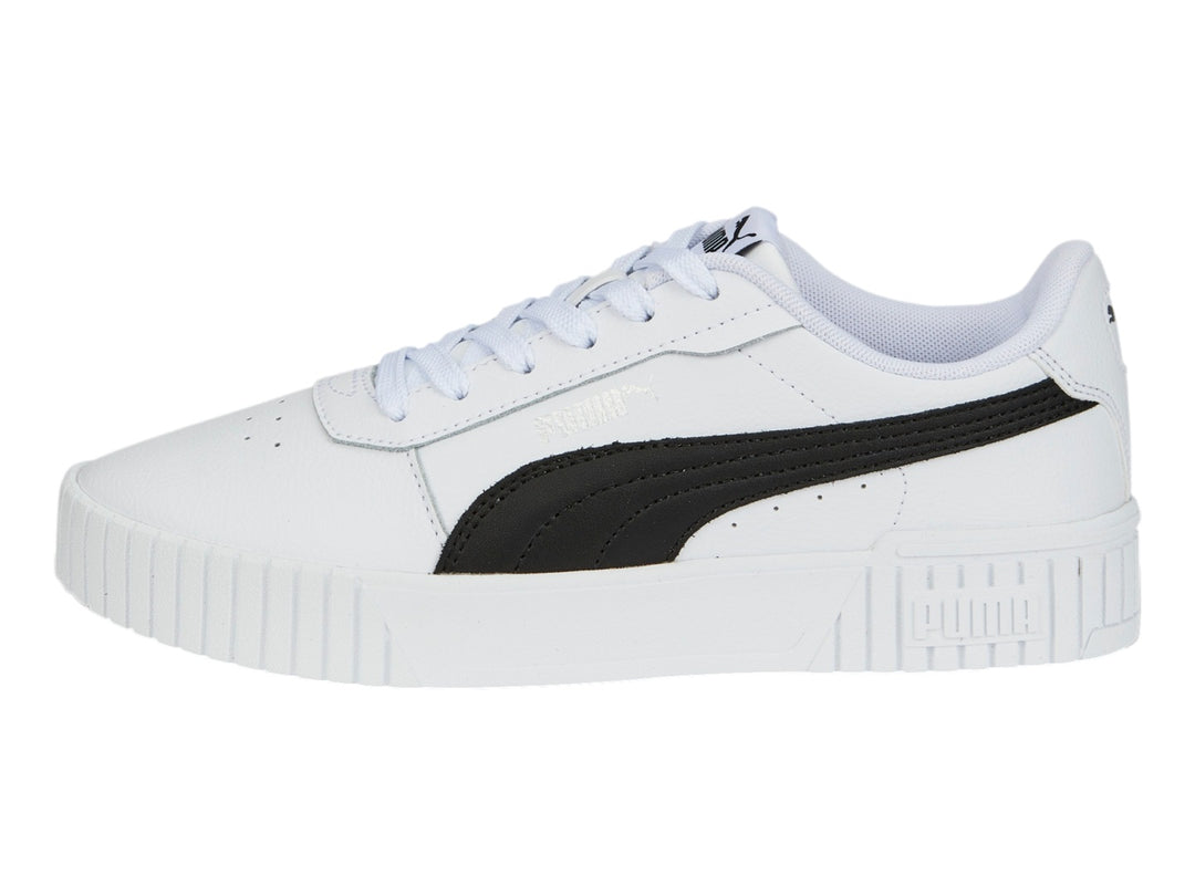 Tenis PUMA Carina 2.0 blancos con franja negra lateral y suela de plataforma blanca.