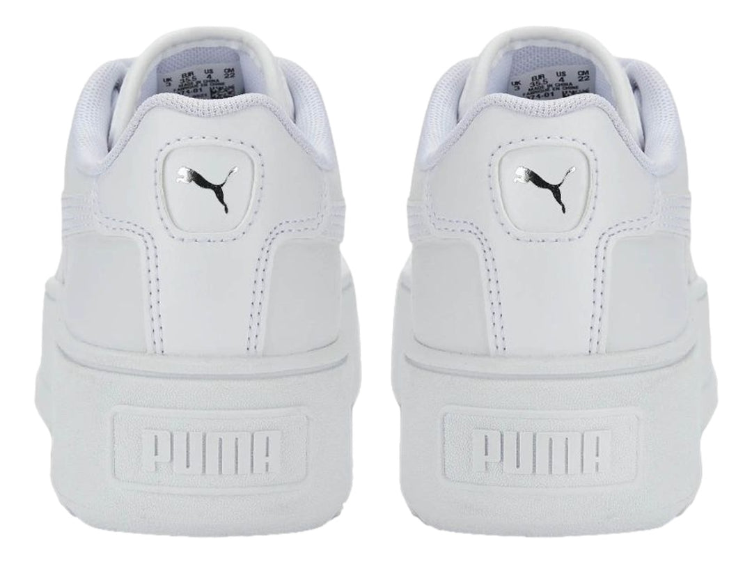 Tenis PUMA blancos con suela de plataforma gruesa y cordones.