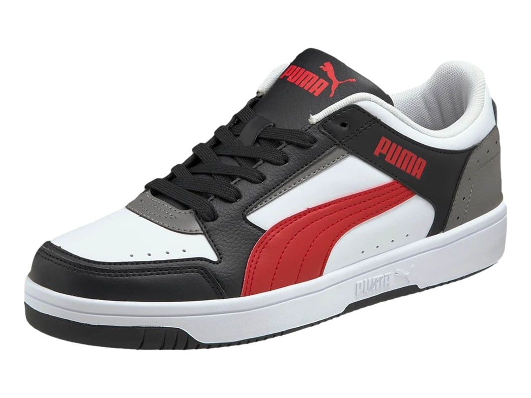 Tenis PUMA Rebound Joy Low en colores blanco, negro, rojo y gris con suela blanca.