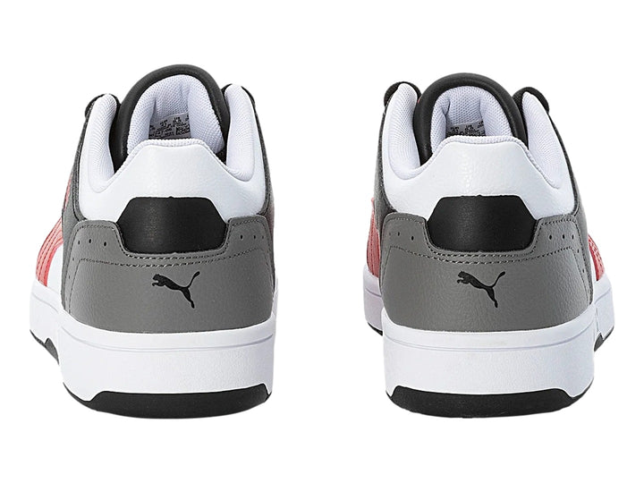 Tenis PUMA Rebound Joy Low en colores blanco, negro, rojo y gris con suela blanca.