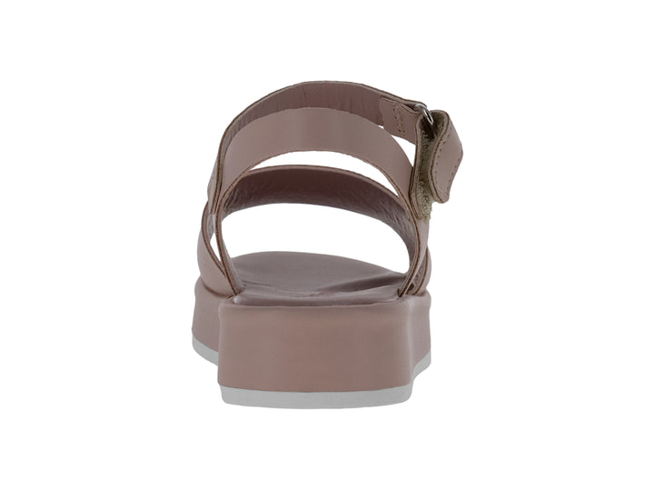 Sandalia de plataforma color nude con correa ajustable al tobillo y suela blanca.
