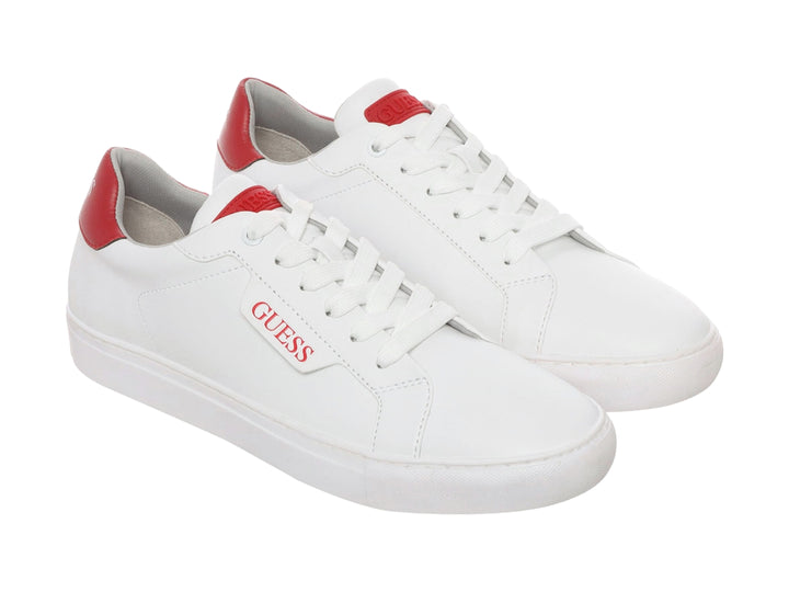 Tenis blancos Guess con detalles rojos en el talón y la lengüeta.