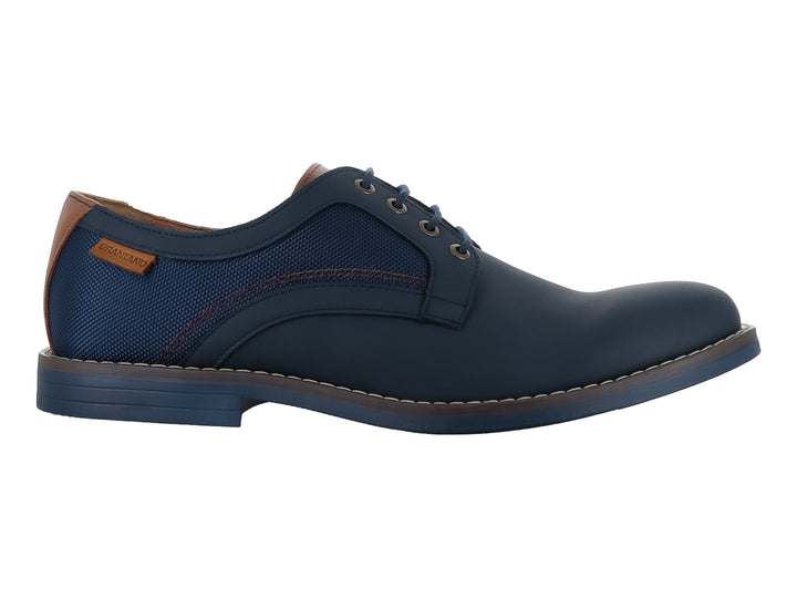 Zapato casual color marino para hombre con detalles en café y cierre de agujetas.