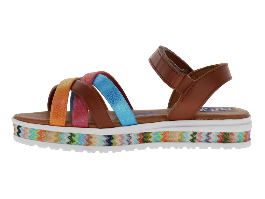 Sandalia color miel con tiras cruzadas en colores rosa, azul y naranja, y suela con diseño zig-zag.