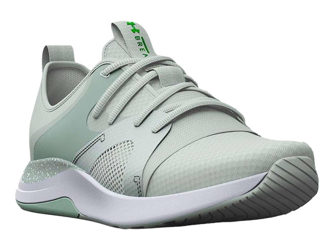 Tenis deportivos Under Armour color verde claro con suela blanca y malla transpirable.