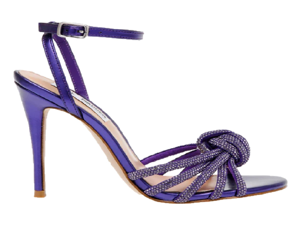 Sandalia de tacón alto color morado con detalle de nudo frontal y correa al tobillo.