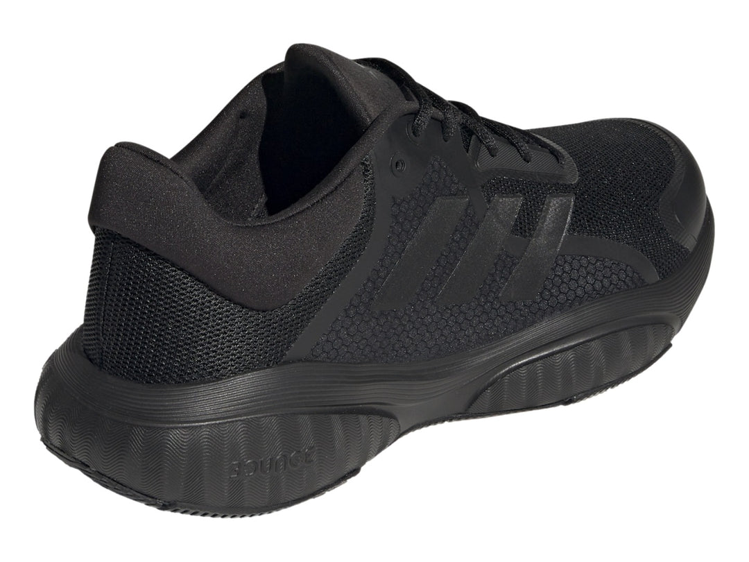 Tenis deportivos Adidas GX2000 en color negro total, vista lateral sobre fondo blanco.