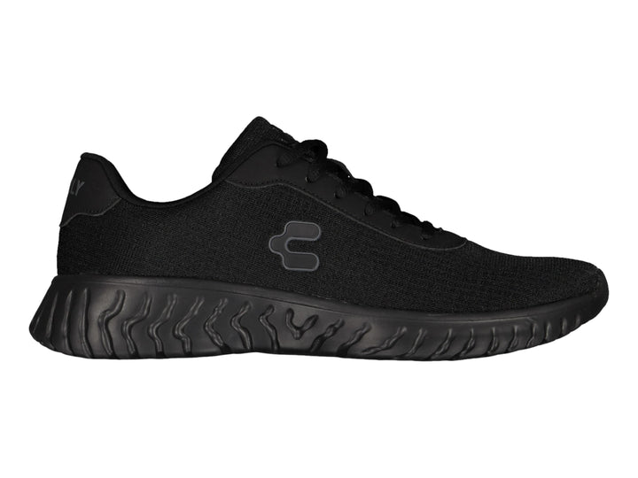 Tenis deportivos Charly color negro con suela ondulada y tejido transpirable.