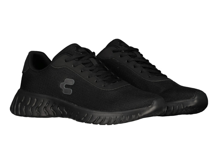 Tenis deportivos Charly color negro con suela ondulada y tejido transpirable.