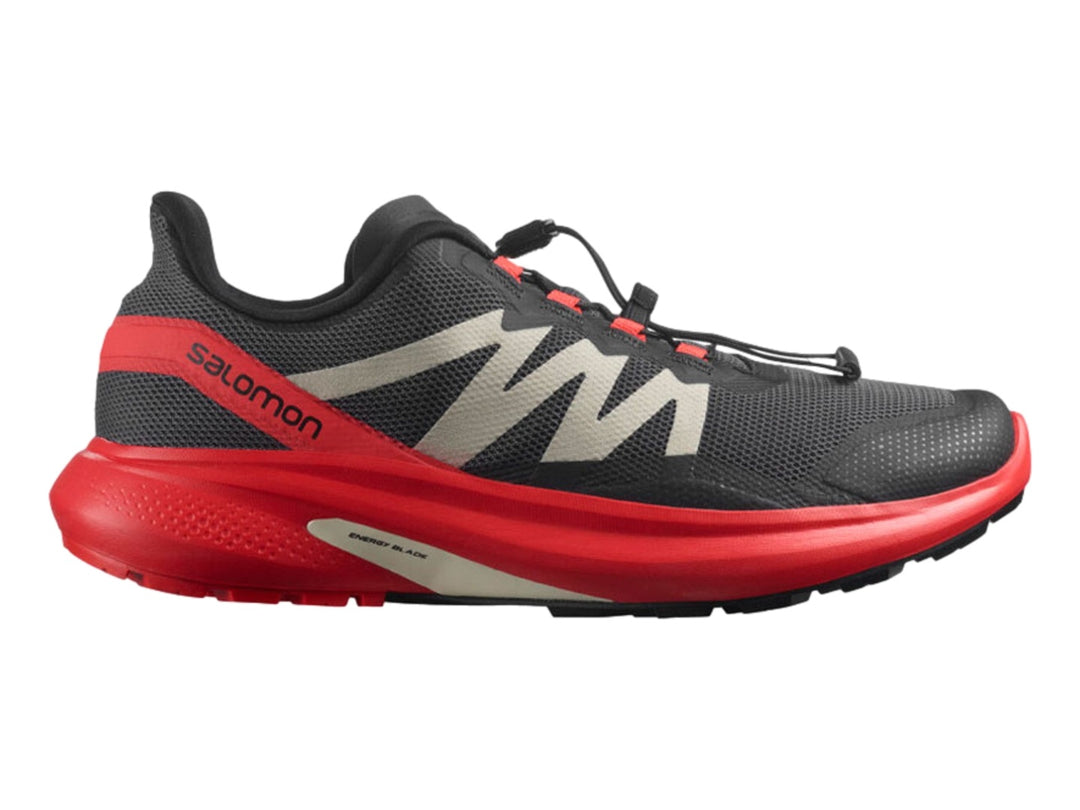 Tenis deportivos Salomon Hypulse en colores gris, rojo y negro con suela amortiguada.