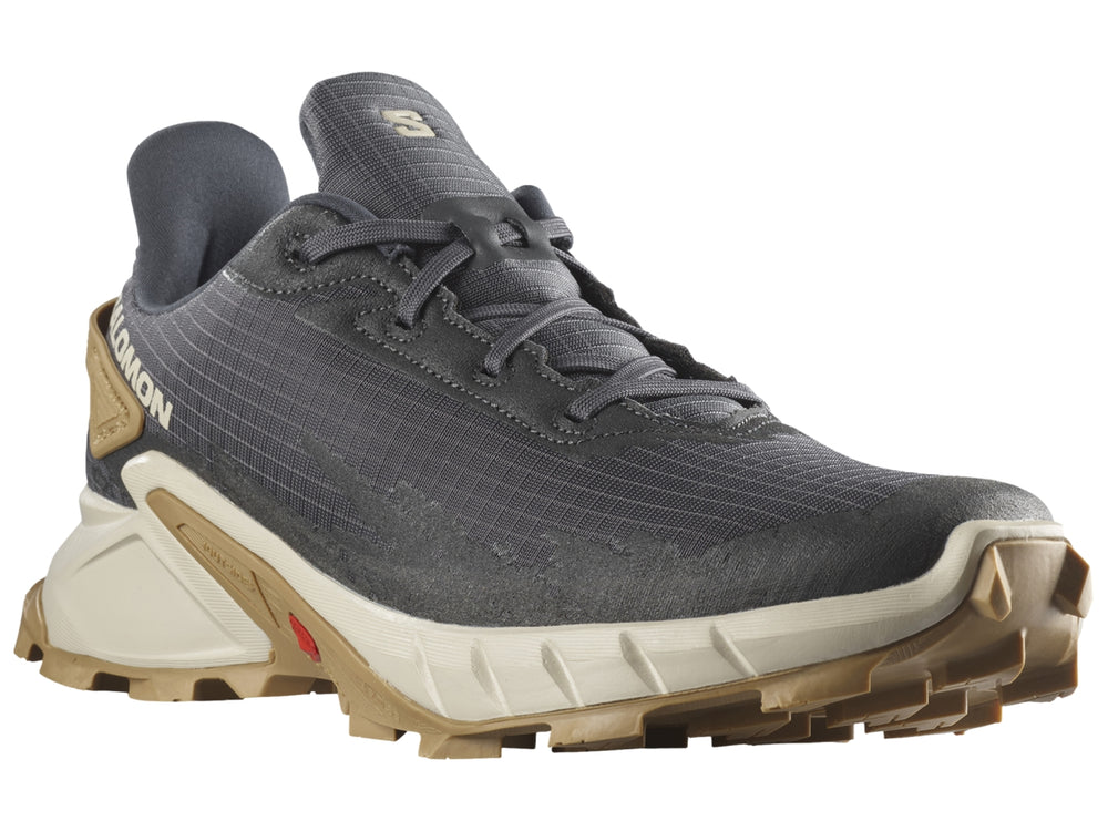 Tenis deportivos Salomon Alphacross en color gris oscuro con suela beige y detalles en blanco.