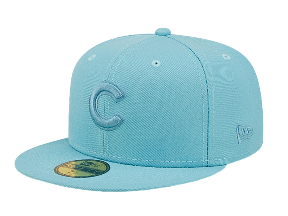 Gorra de béisbol New Era en color azul pastel con letra C bordada al frente y visera plana.