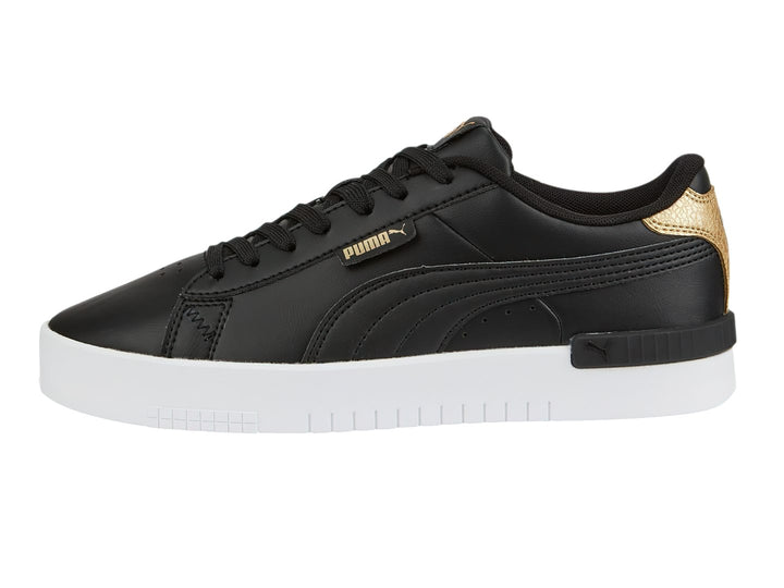 Tenis PUMA color negro con detalles en dorado y suela blanca.