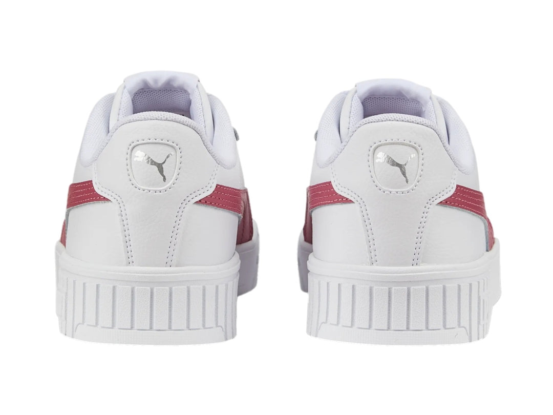 Tenis PUMA Carina 2.0 blancos con franja rosa y suela de plataforma blanca.
