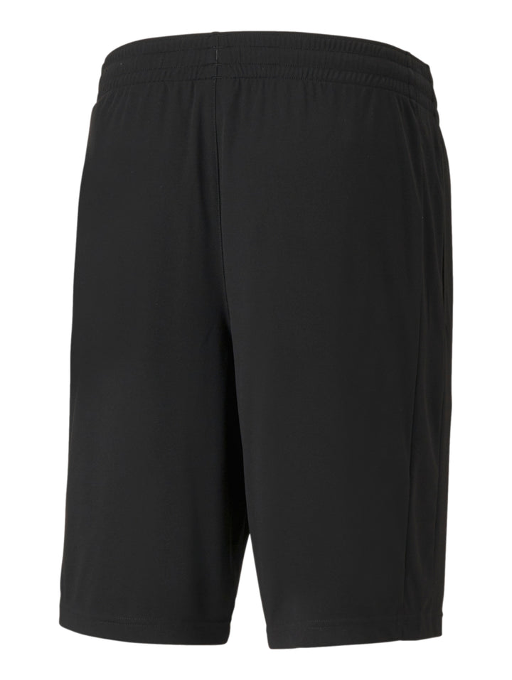 Hombre vistiendo shorts deportivos PUMA de color negro con logo blanco en la pierna izquierda.