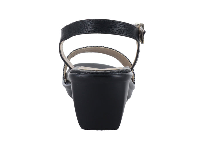 Sandalia negra para mujer con tacón de cuña, correa al tobillo con hebilla y banda frontal trenzada en color plata.