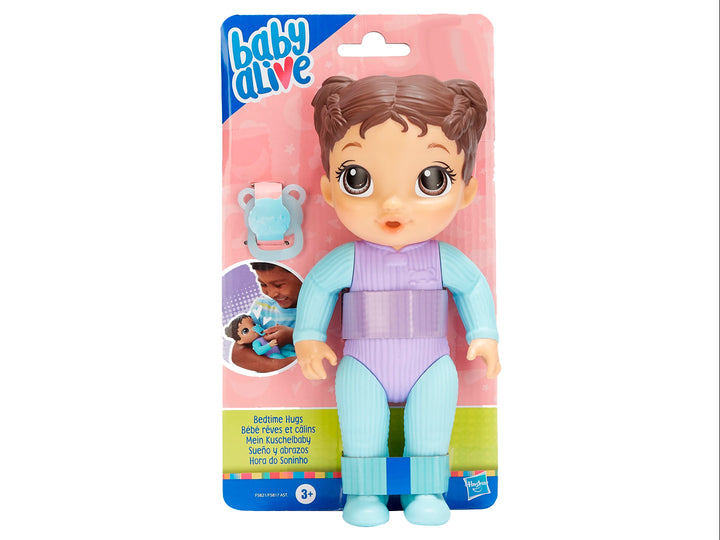 Muñeca Baby Alive con pijama azul y morada, incluye chupón, en empaque rosa.