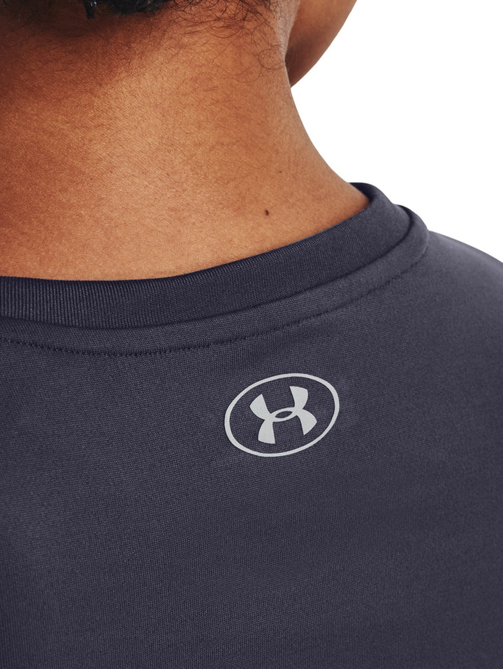 Mujer vistiendo una camiseta deportiva de manga corta color gris oscuro de la marca Under Armour.