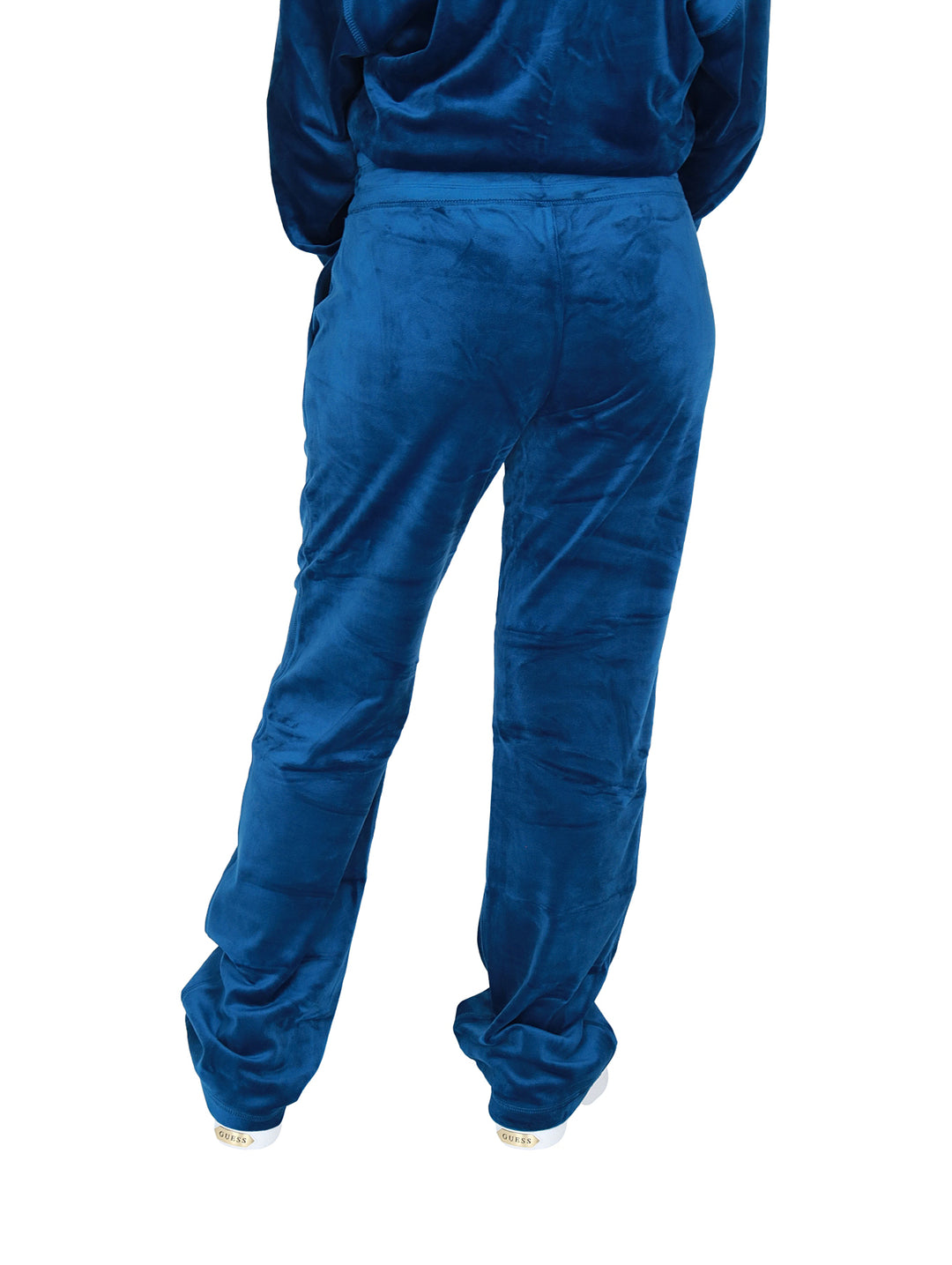 Pantalones deportivos DKNY color azul Poseidon en tela velour con logo de pedrería.