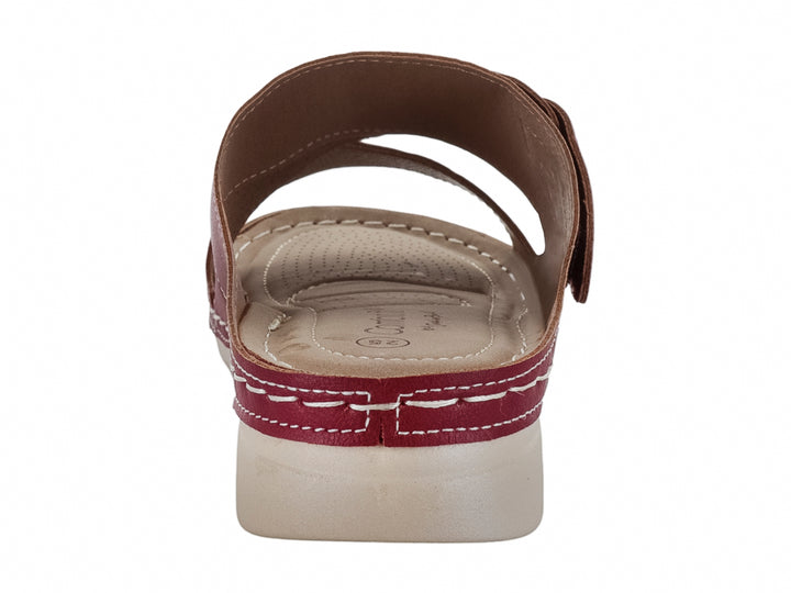 Sandalia roja de material sintético con correas perforadas, hebilla metálica y suela blanca contrastante.