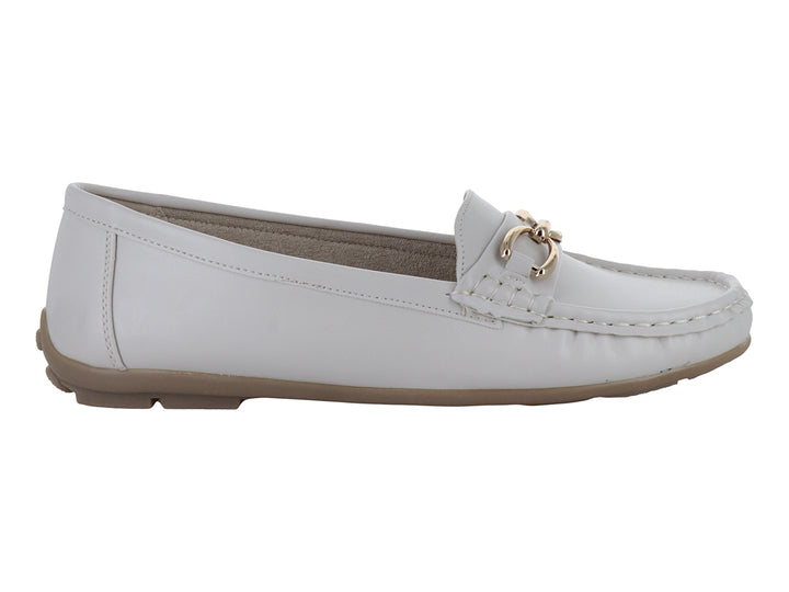 Mocasines color beige para mujer con detalle de cadena dorada en la parte superior.