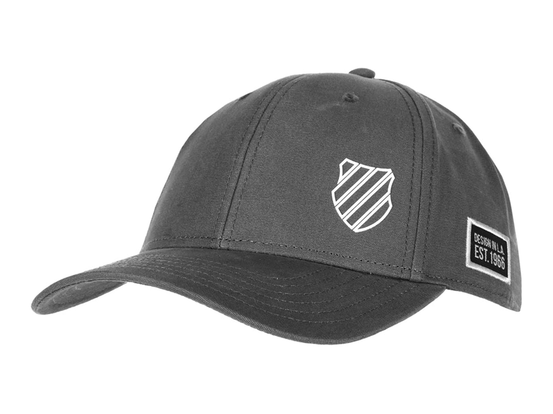 Gorra de béisbol K-Swiss en color gris con logotipo blanco frontal y etiqueta lateral.