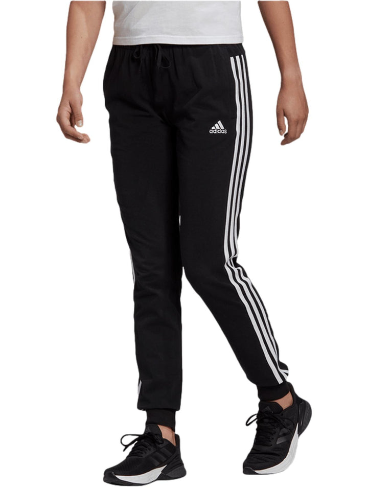 Pantalones deportivos negros Adidas con tres franjas blancas laterales y puños en los tobillos.