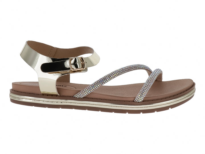 Sandalia plana color oro inglés con tiras decoradas con brillos y correa ajustable al tobillo para Mujer.