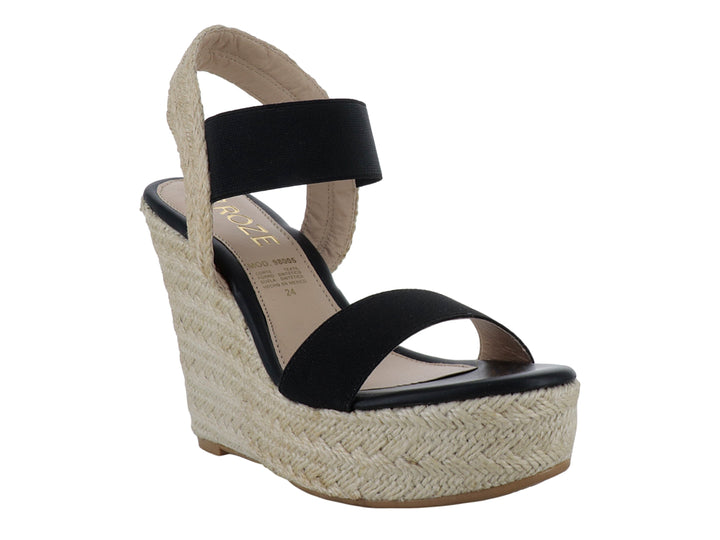 Sandalia de plataforma para mujer en color negro con base de yute beige y tira elástica en el tobillo.