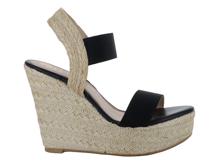 Sandalia de plataforma para mujer en color negro con base de yute beige y tira elástica en el tobillo.