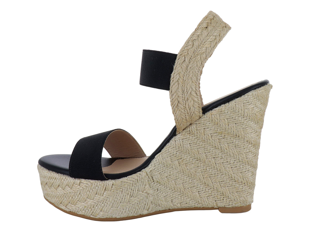 Sandalia de plataforma para mujer en color negro con base de yute beige y tira elástica en el tobillo.