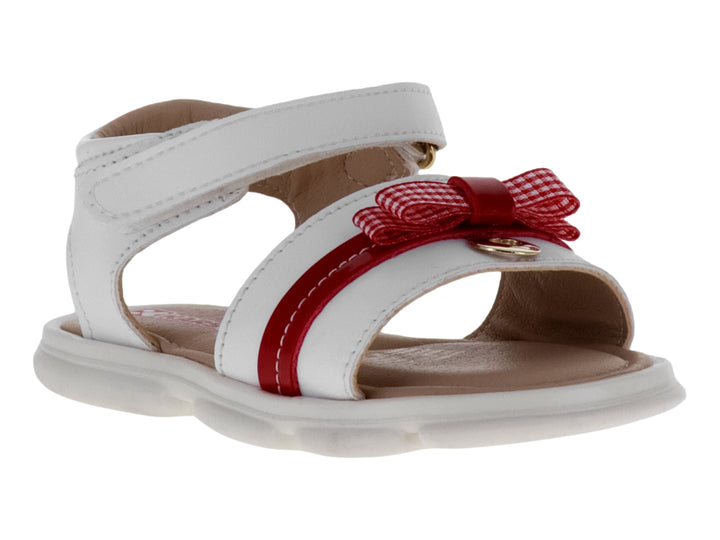 Sandalia blanca para Niña con detalle de moño rojo y correa ajustable en el tobillo.