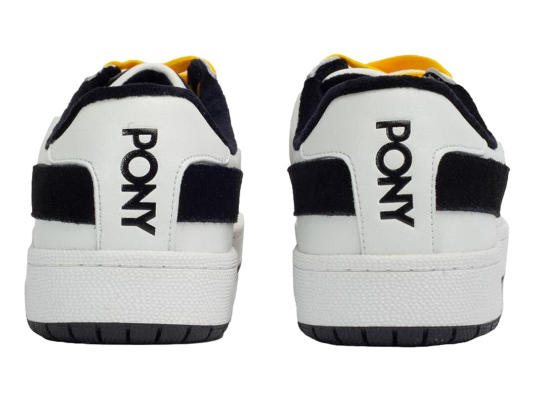 Tenis PONY blancos con franja negra lateral, agujetas amarillas y punta gris.