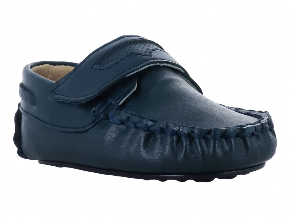 Zapato tipo mocasín color azul marino para bebé con cierre de velcro y costuras decorativas.