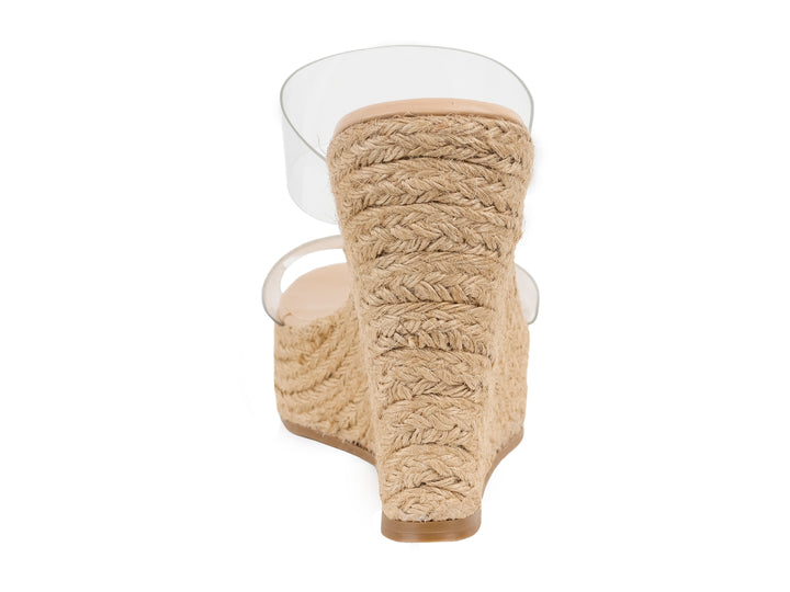 Sandalia Steve Madden Sedate Clear con tiras transparentes y plataforma de cuña en color beige.